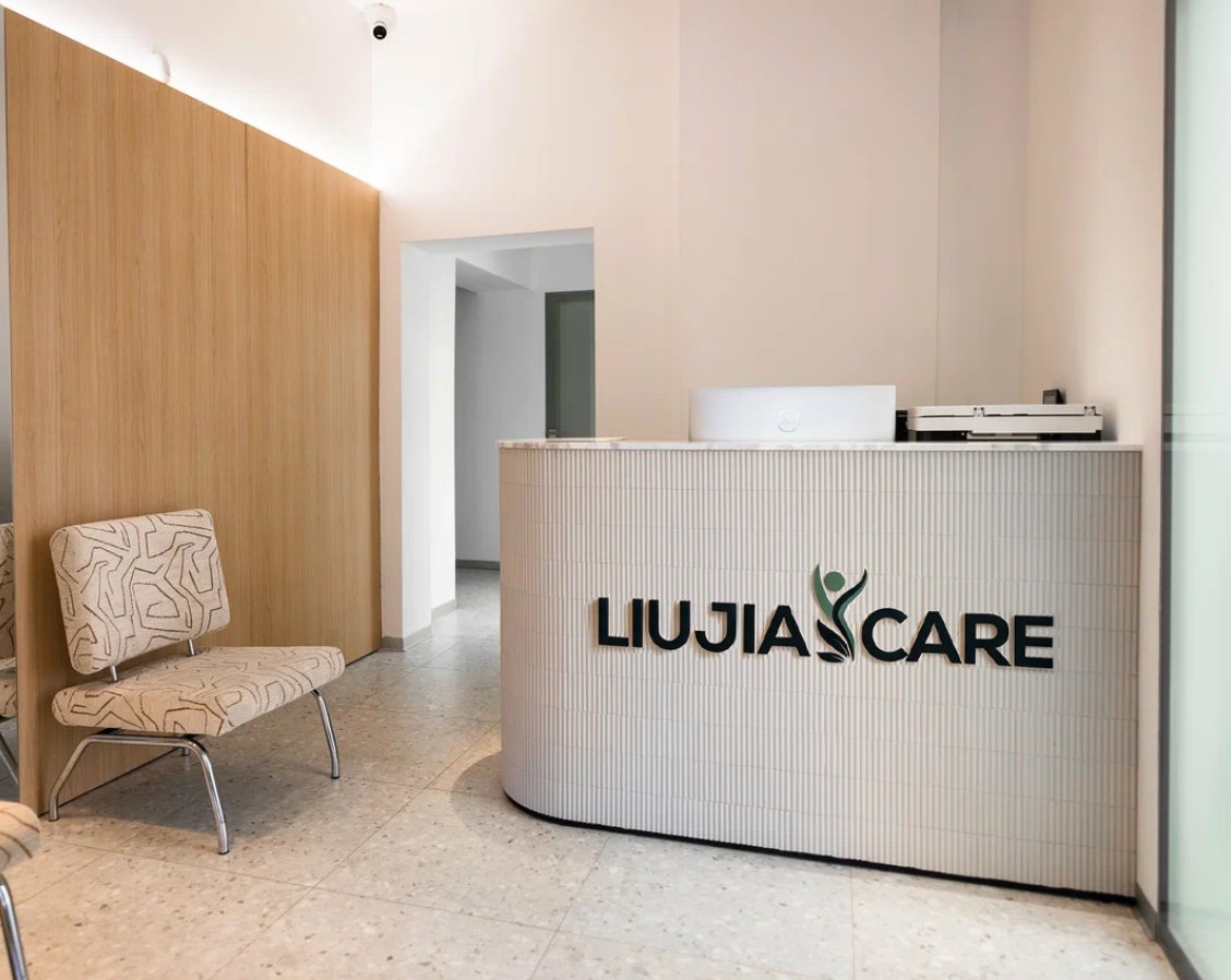 Liujia Care reception area with wood paneling and branded welcome desk